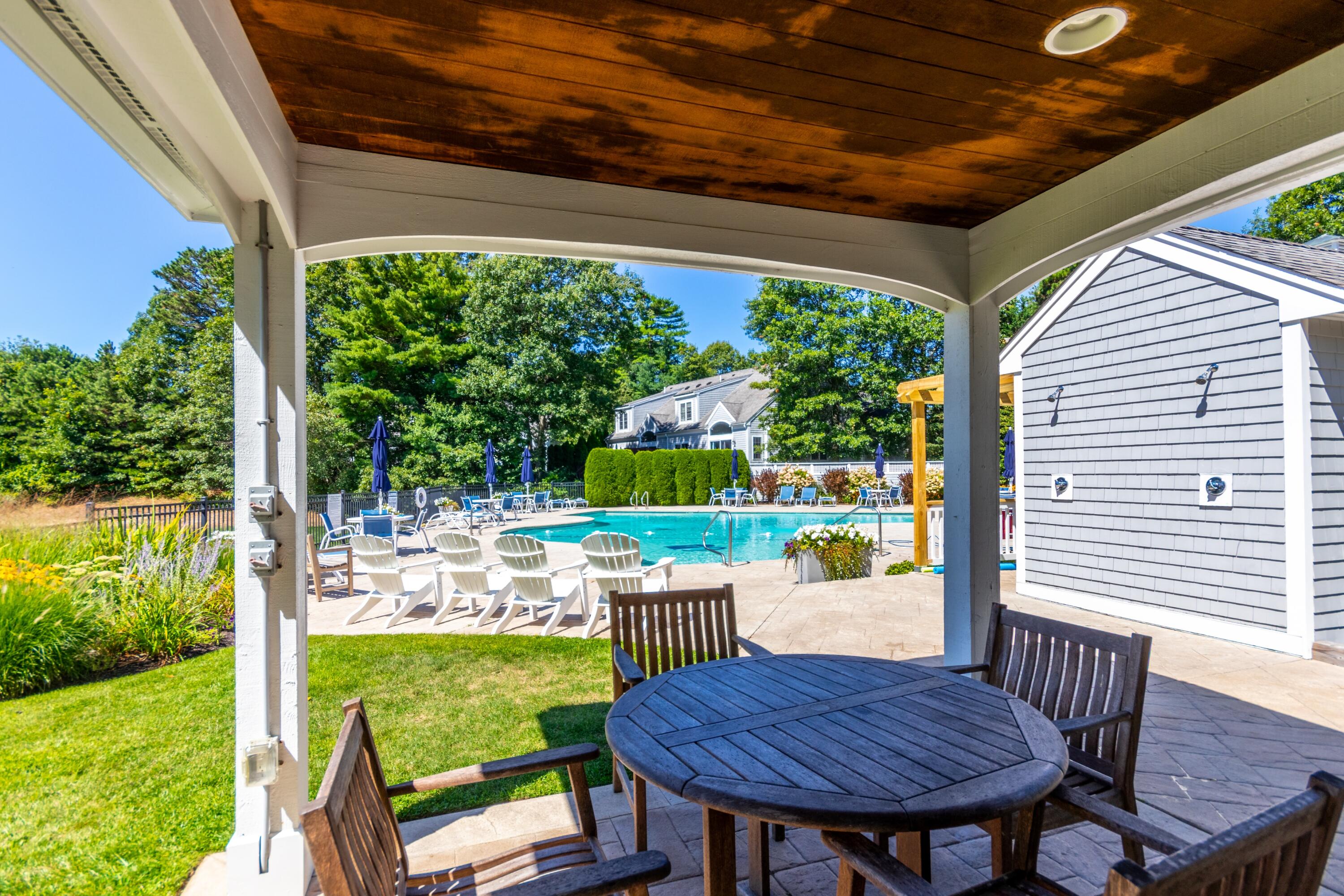 26 Carnoustie Road Bourne, MA 02532 - Photo 42 of 46 a view of a patio with a table chairs and a backyard