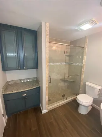 a bathroom with a sink toilet and shower
