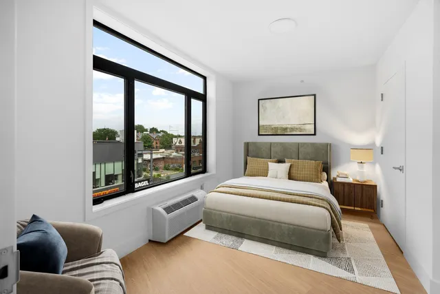 a bedroom with a bed and glass window