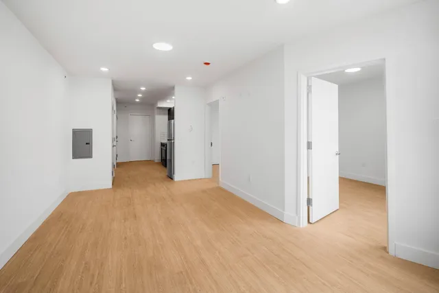 a view of empty room with wooden floor