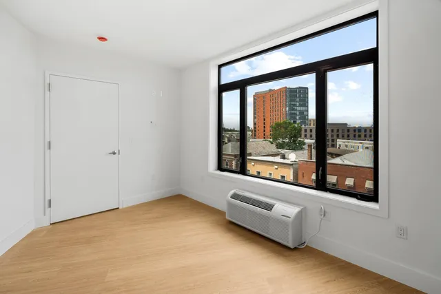 a bedroom with a large bed and a large window