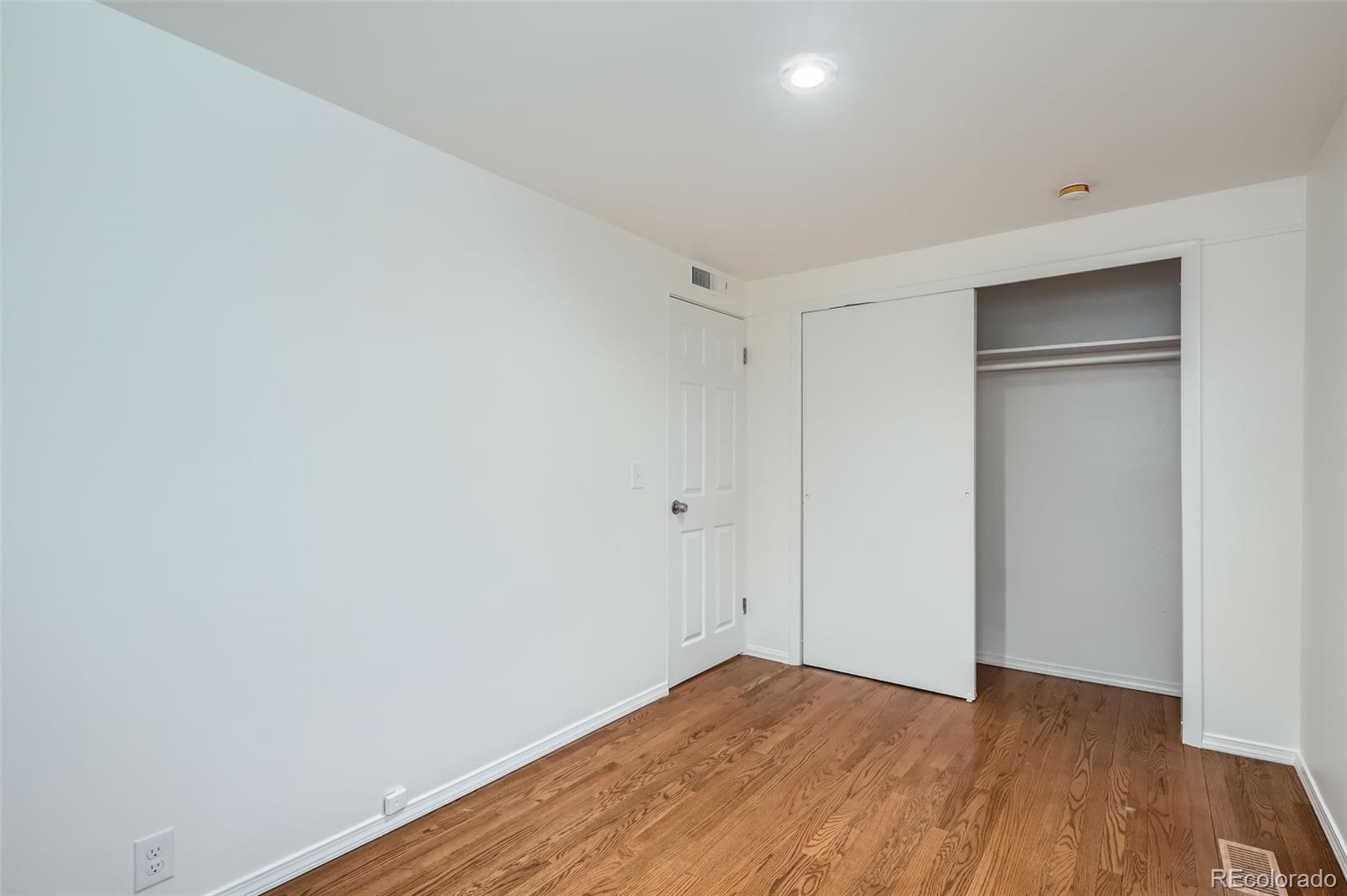 1720 South Java Way Denver, CO 80219 - Photo 14 of 28 a view of an empty room with wooden floor & closet