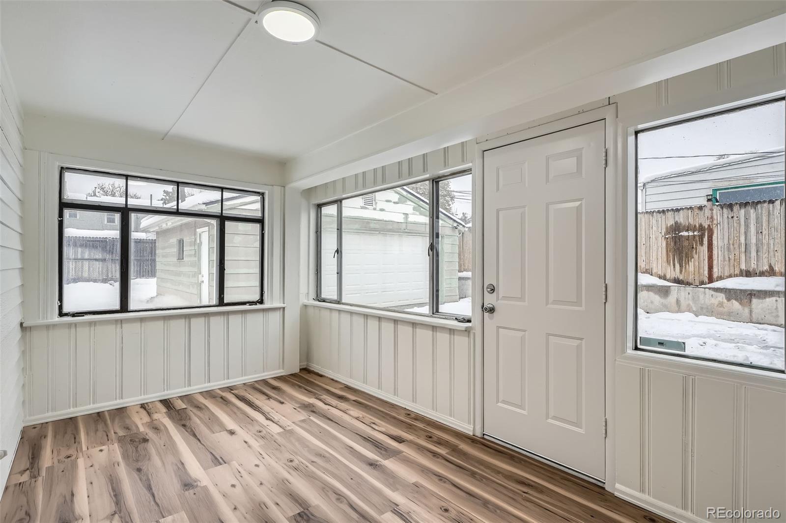 1720 South Java Way Denver, CO 80219 - Photo 22 of 28 a view of an empty room with wooden floor and a window