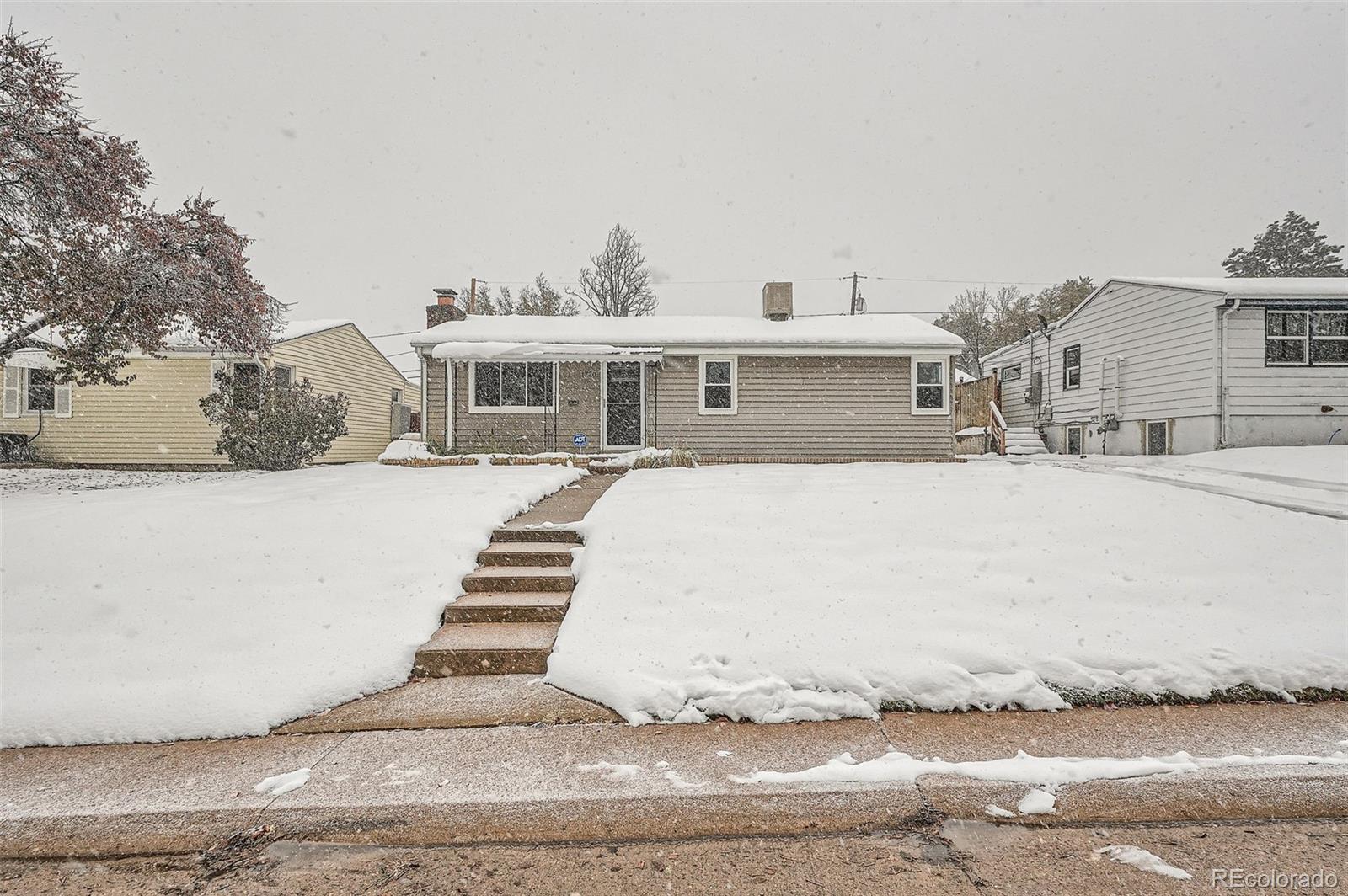 1720 South Java Way Denver, CO 80219 - Photo 23 of 28 a front view of a house with a yard