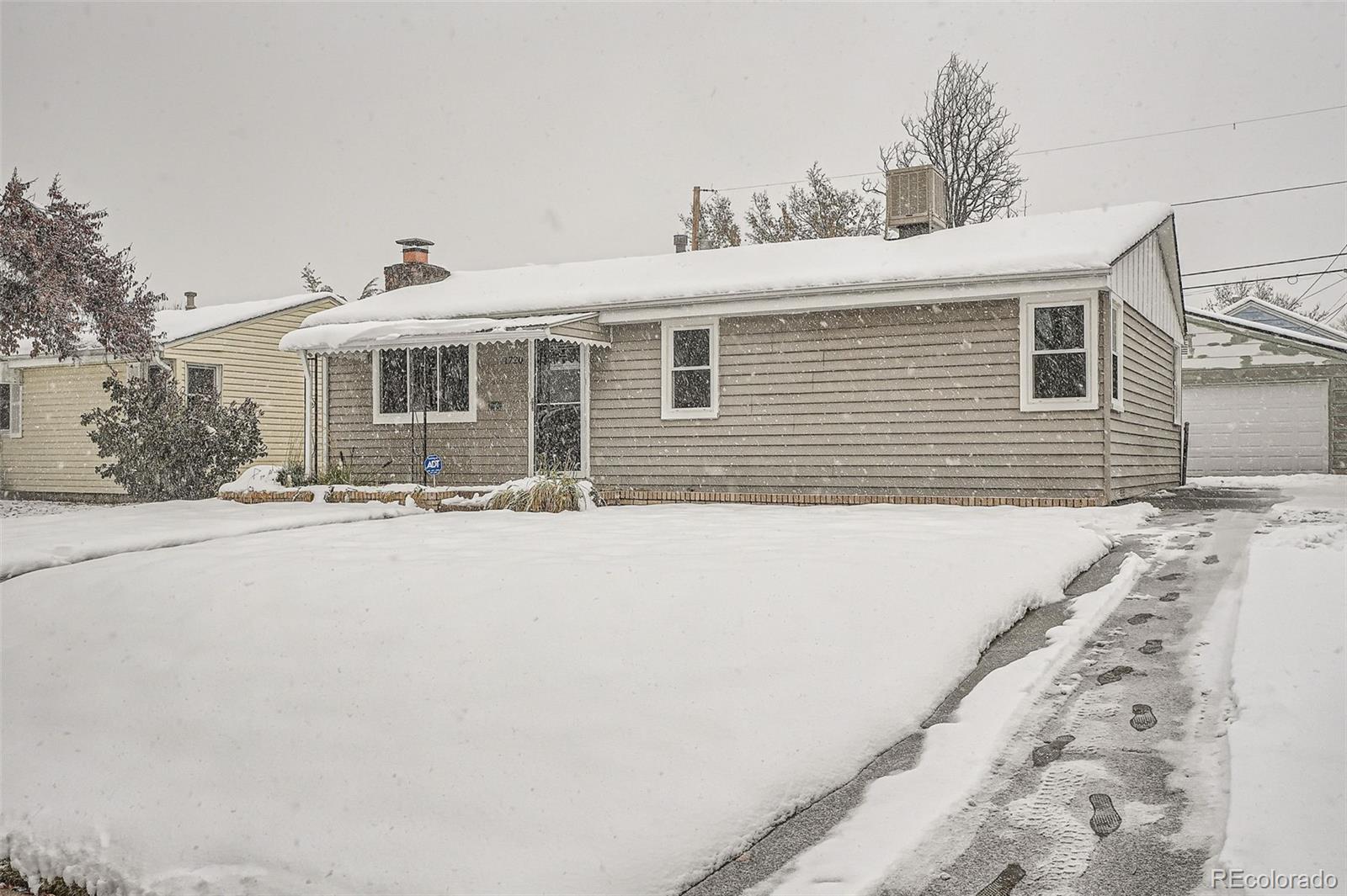 1720 South Java Way Denver, CO 80219 - Photo 25 of 28 a front view of a house with a yard and garage