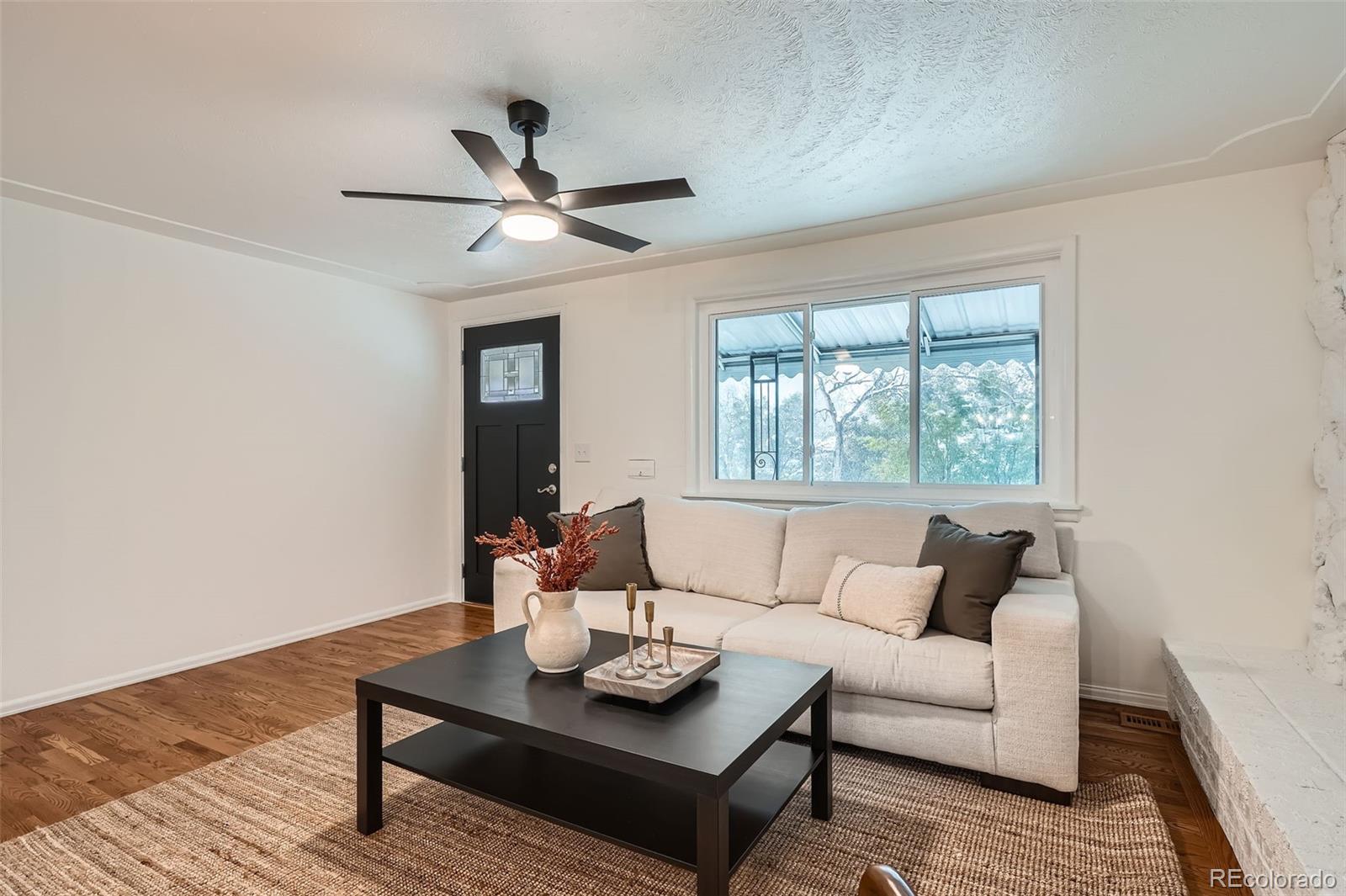 1720 South Java Way Denver, CO 80219 - Photo 3 of 28 a living room with furniture and a window