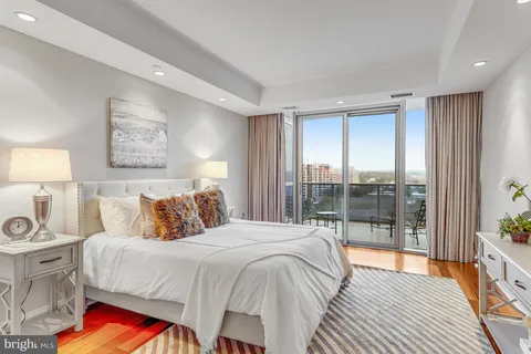 a bedroom with a large bed and a lamp