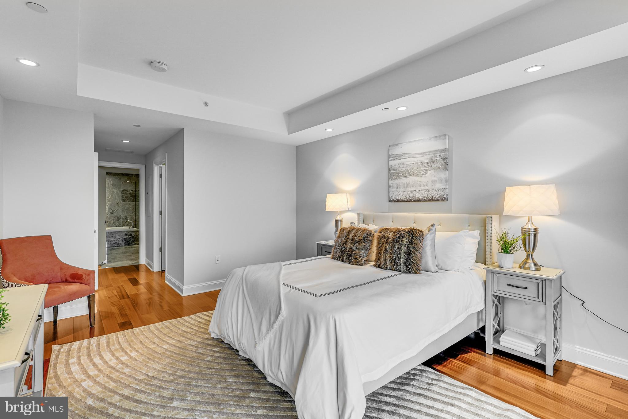 1881 North Nash Street, Unit 1706 Arlington, VA 22209 - Photo 13 of 50 a bedroom with a bed and wooden floor