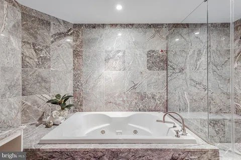 a bathroom with a bath tub and shower