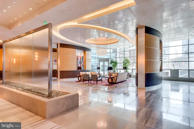 a lobby with furniture and floor to ceiling window