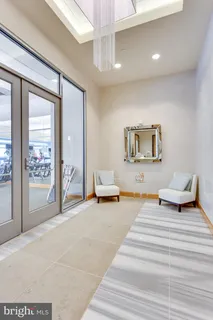 a bedroom with furniture and a mirror