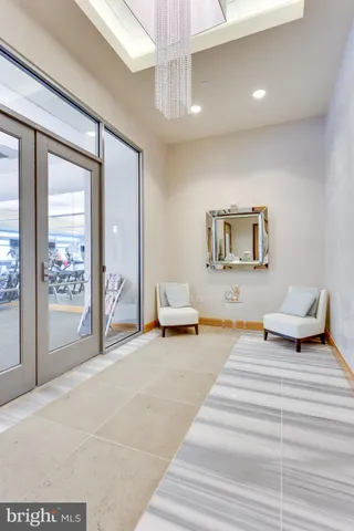 a bedroom with furniture and a mirror