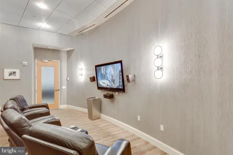 a bedroom with furniture and a wooden floor