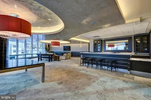 a living room with furniture a pool table and chairs