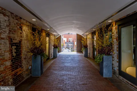 a view of a hallway with wooden shelves