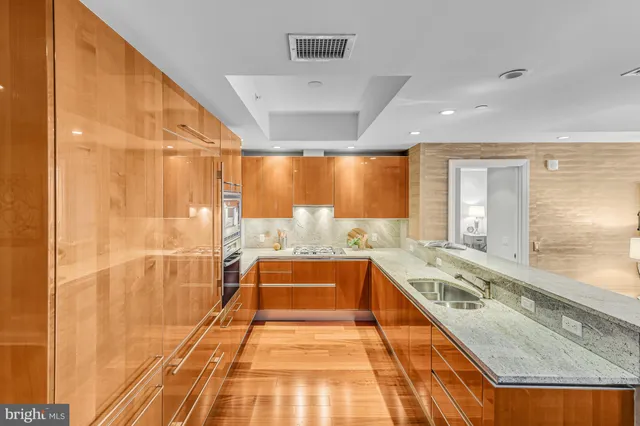 a large white kitchen with a large window