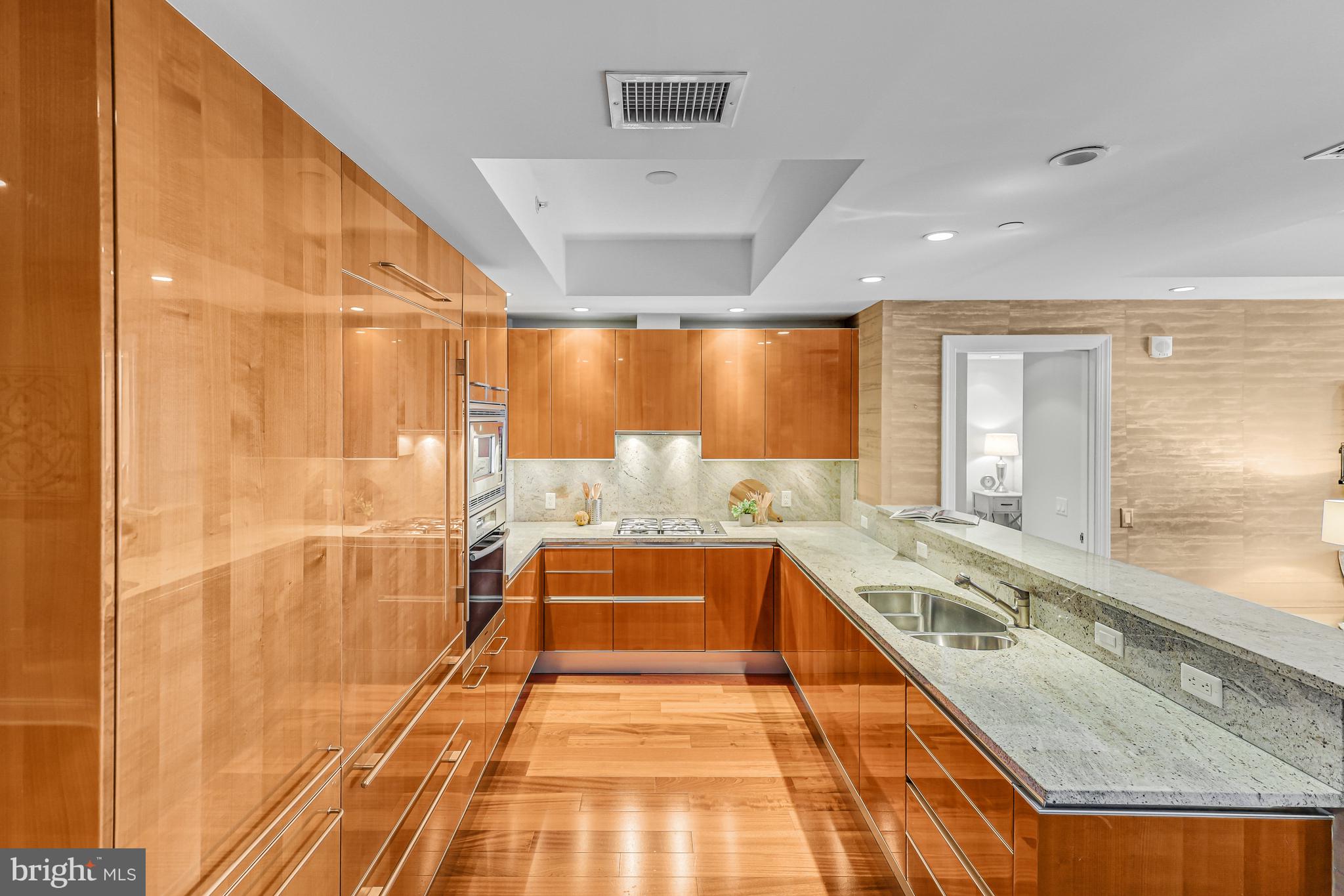 1881 North Nash Street, Unit 1706 Arlington, VA 22209 - Photo 7 of 50 a large white kitchen with a large window