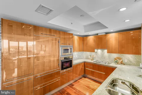 a kitchen with stainless steel appliances granite countertop a sink and cabinets