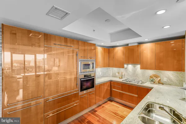 a kitchen with stainless steel appliances granite countertop a sink and cabinets
