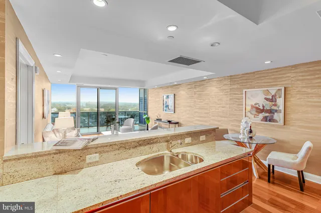 a kitchen with stainless steel appliances granite countertop sink and wooden cabinets