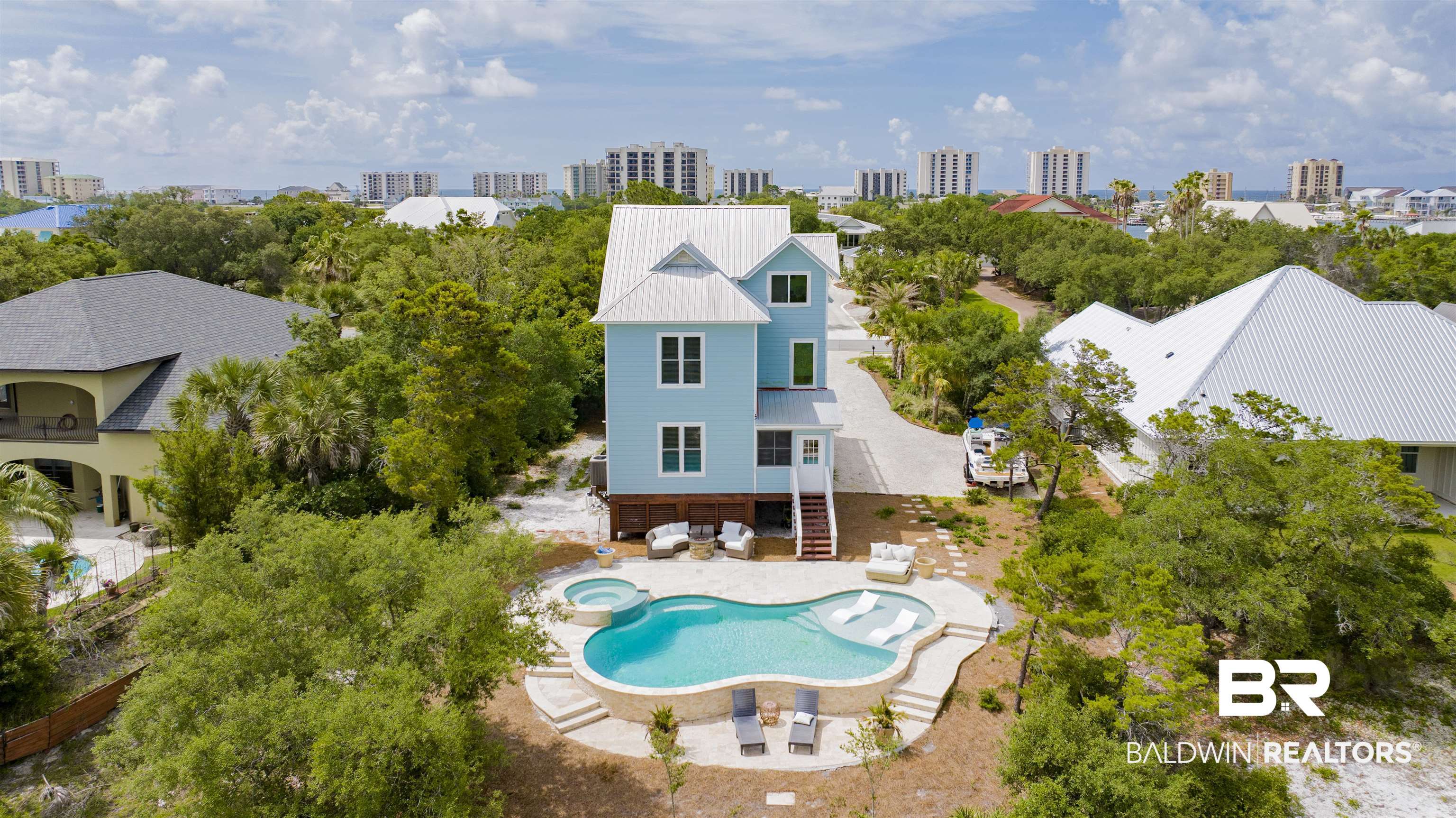 30351 River Road Orange Beach, AL 36561 - Photo 43 of 44 Coastal-inspired residence featuring a light blue exterior, white trim, and a metal roof