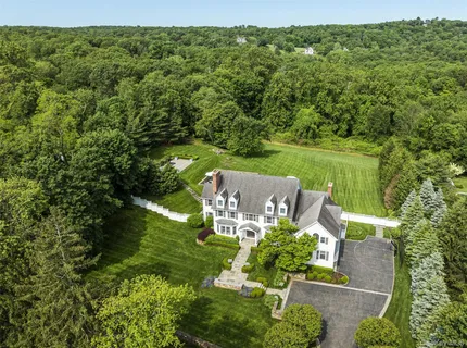an aerial view of a house with a yard basket ball court and outdoor seating