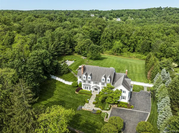 an aerial view of a house with a yard basket ball court and outdoor seating