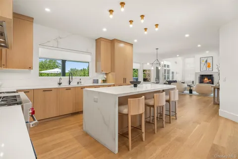 a large kitchen with kitchen island a sink table and chairs