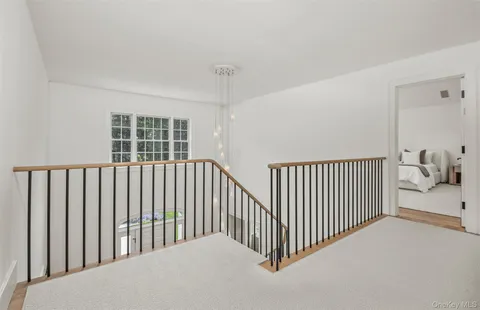 a spacious bedroom with a bed a couch and large window