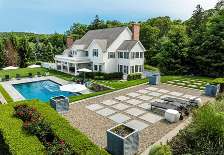 an aerial view of a house with swimming pool garden and patio
