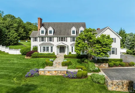 a front view of a house with a yard table and chairs