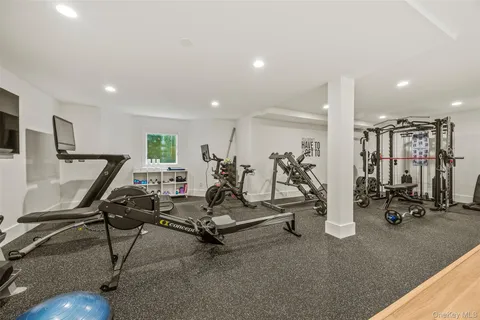 an aerial view of a house with pool and a yard