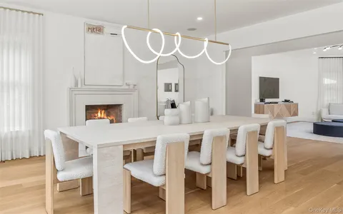a kitchen with a table chairs and a fireplace