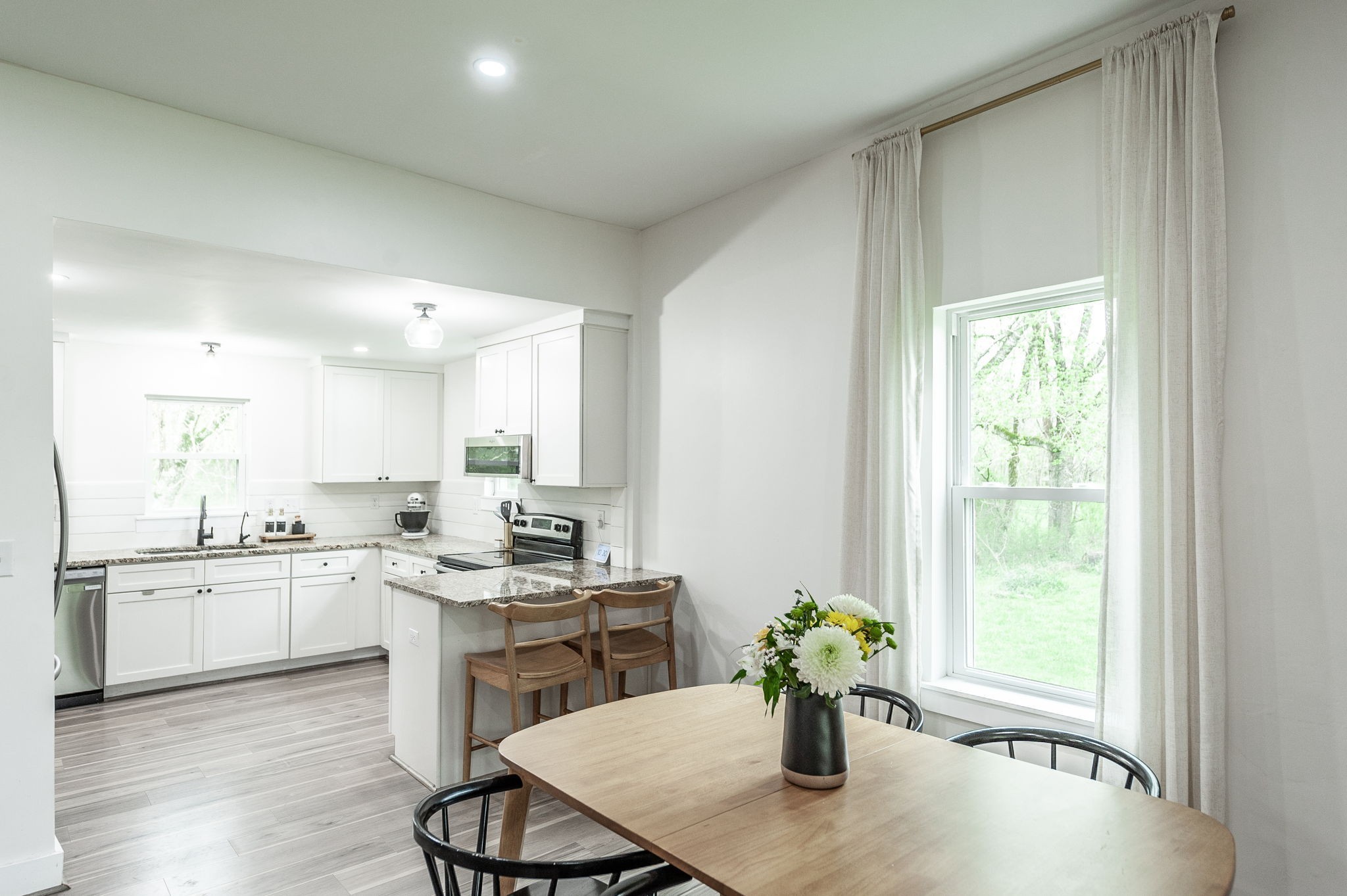 375 Mt Vernon Road Bethpage, TN 37022 - Photo 21 of 66 a kitchen with a sink a center island and wooden cabinets