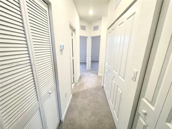 a view of a hallway with a white door