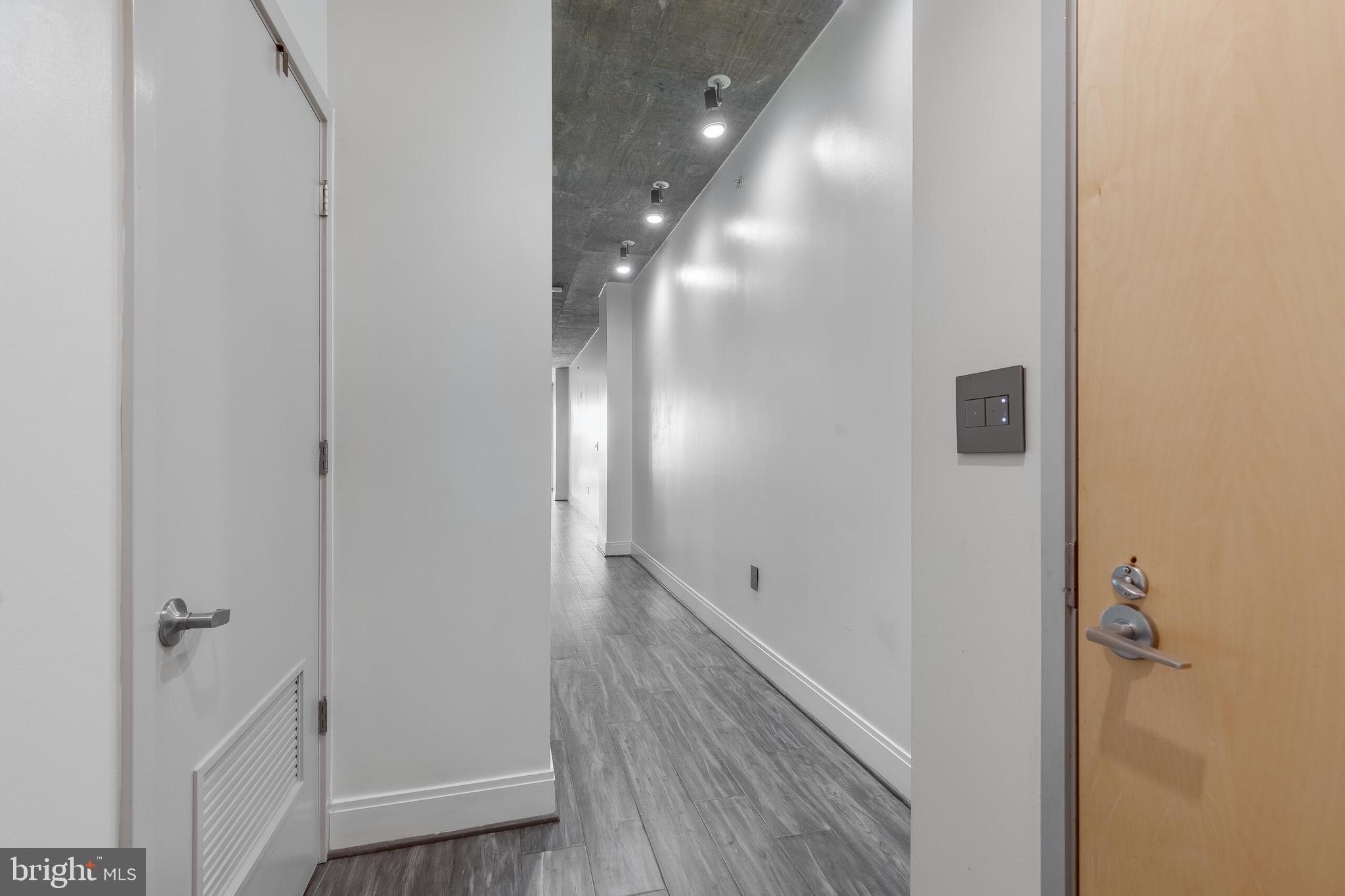 929 Florida Avenue Northwest, Unit 2001 Washington, DC 20001 - Photo 21 of 42 a view of a hallway with wooden floor