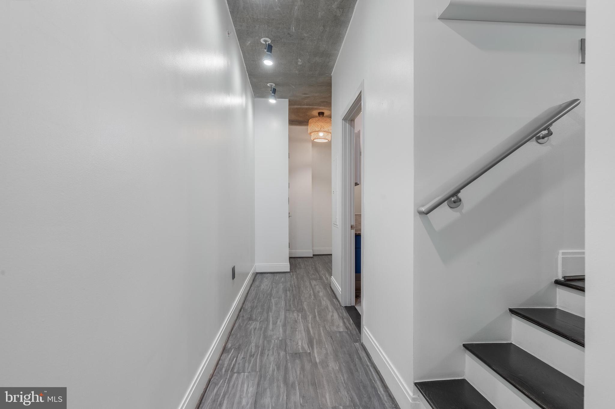 929 Florida Avenue Northwest, Unit 2001 Washington, DC 20001 - Photo 23 of 42 a view of a hallway with wooden floor and staircase