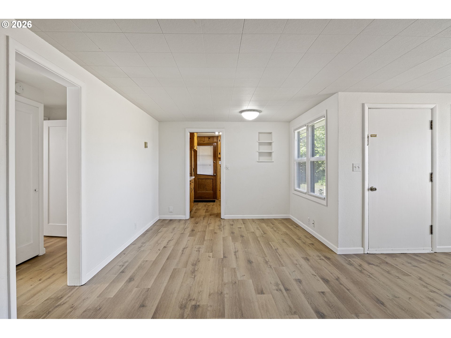 1008 Coburg Road Eugene, OR 97401 - Photo 31 of 46 a view of an empty room with wooden floor and a window