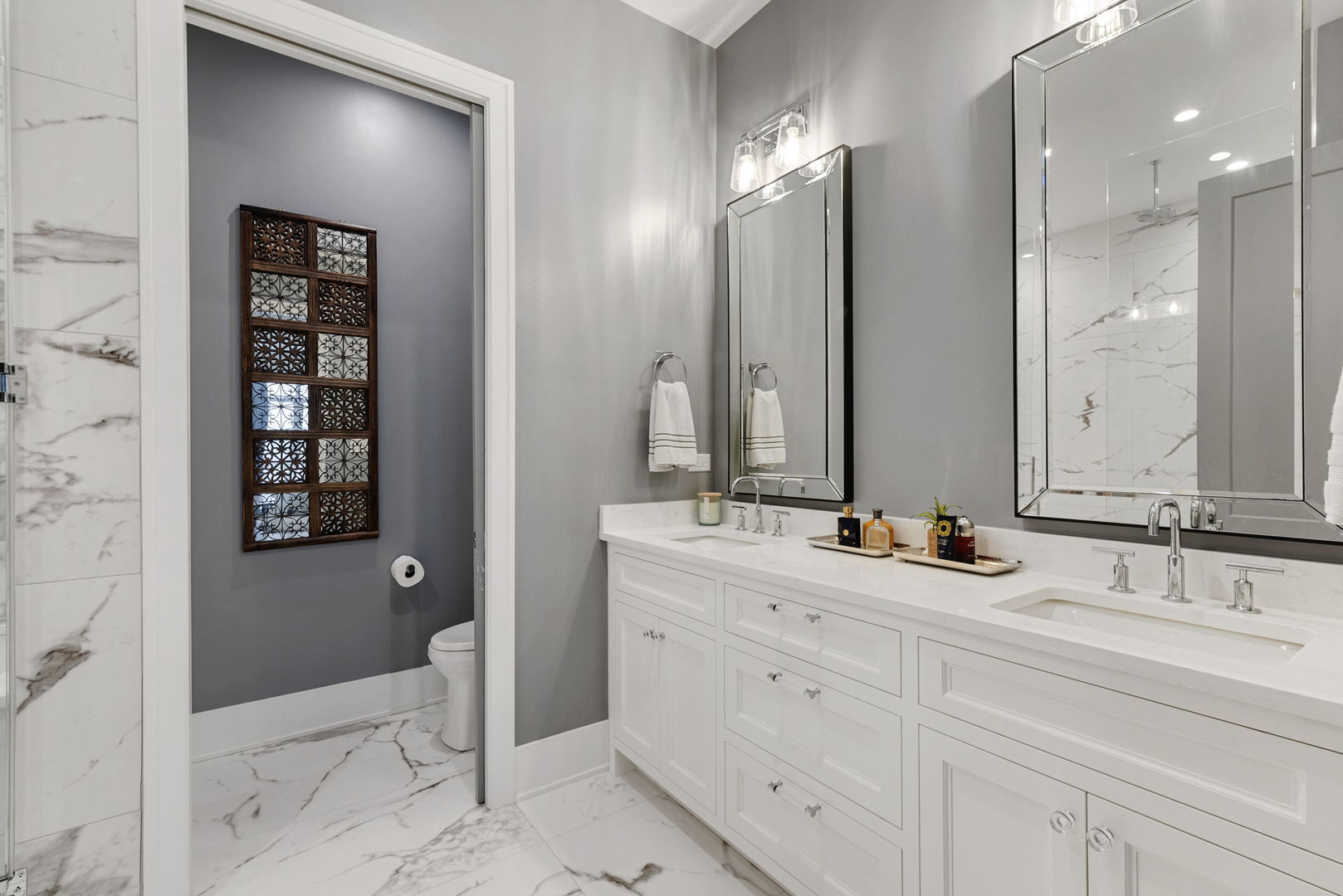 195 North Addison Avenue, Unit 303 Elmhurst, IL 60126 - Photo 16 of 30 a bathroom with a double vanity sink a toilet and shower
