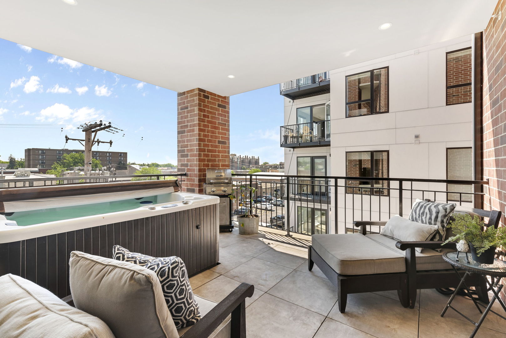 195 North Addison Avenue, Unit 303 Elmhurst, IL 60126 - Photo 9 of 30 a balcony with furniture and a potted plant