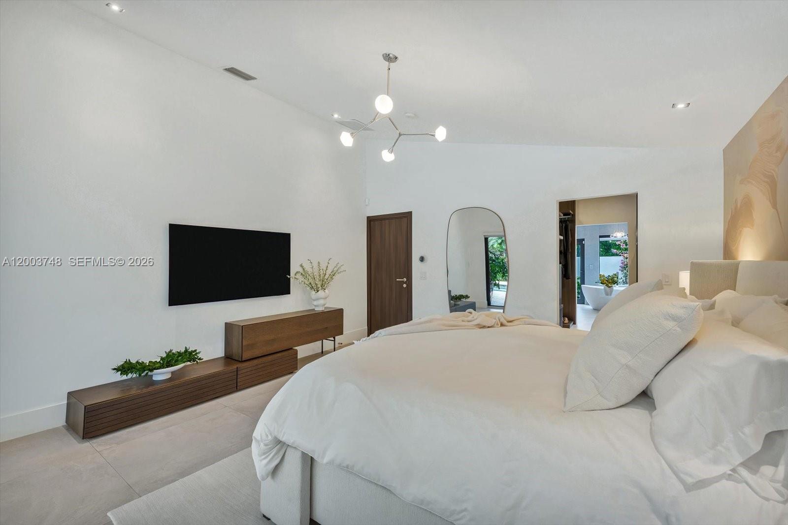 2675 Hackney Road Weston, FL 33331 - Photo 40 of 61 a bedroom with a bed and a flat screen tv