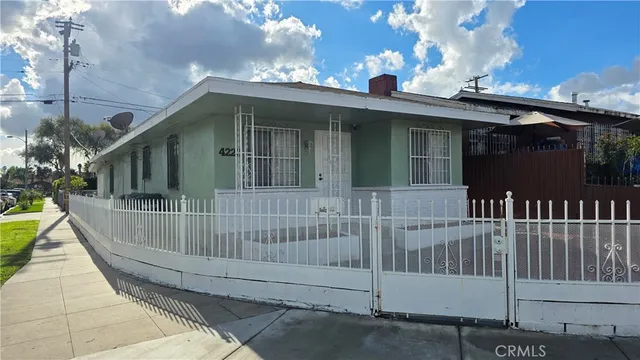 a view of a house with a wooden deck