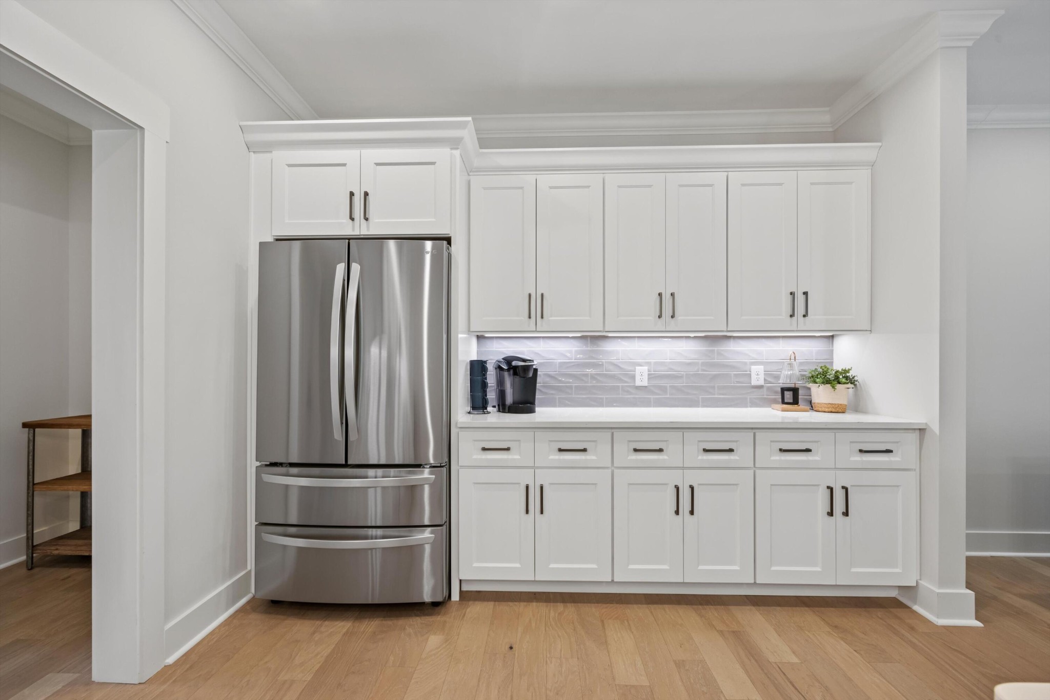 9638 Dutton Lane Ooltewah, TN 37363 - Photo 14 of 38 a kitchen with cabinets stainless steel appliances and wooden floor