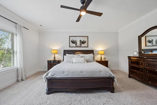 a spacious bedroom with a bed and dresser