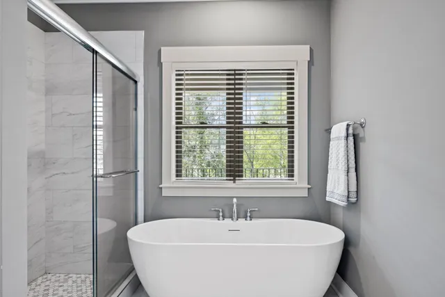 a bathroom with a double vanity sink toilet and shower
