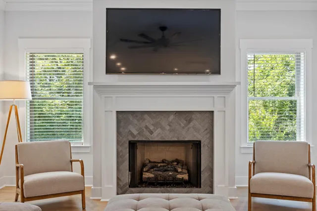a living room with furniture a fireplace and a flat screen tv