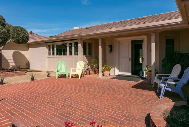 a front view of house with outdoor seating