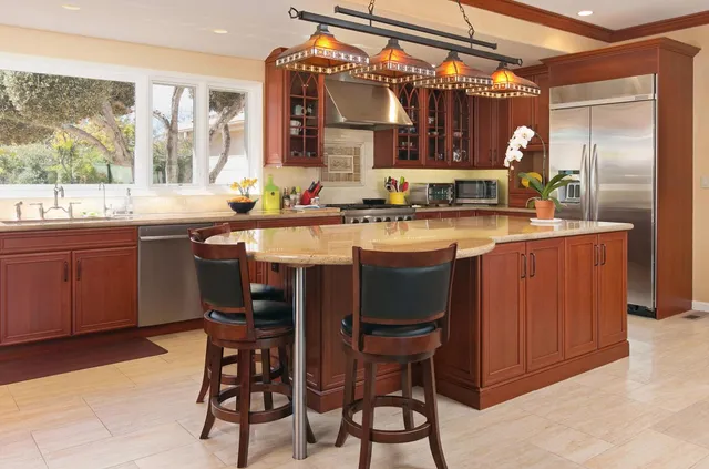 a kitchen with a sink and chairs