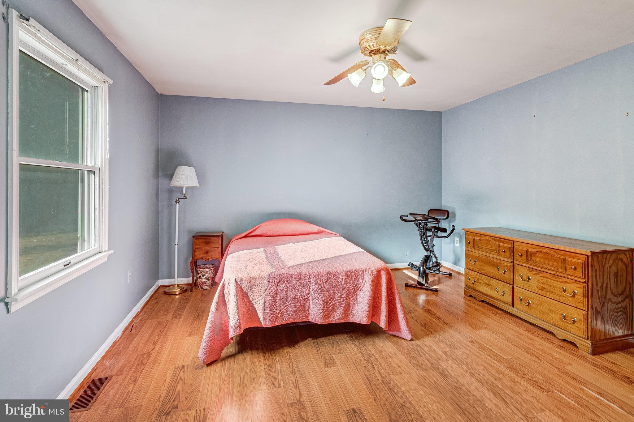 13200 Marsh Road Bealeton, VA 22712 - Photo 11 of 20 a bedroom with a bed and a chandelier