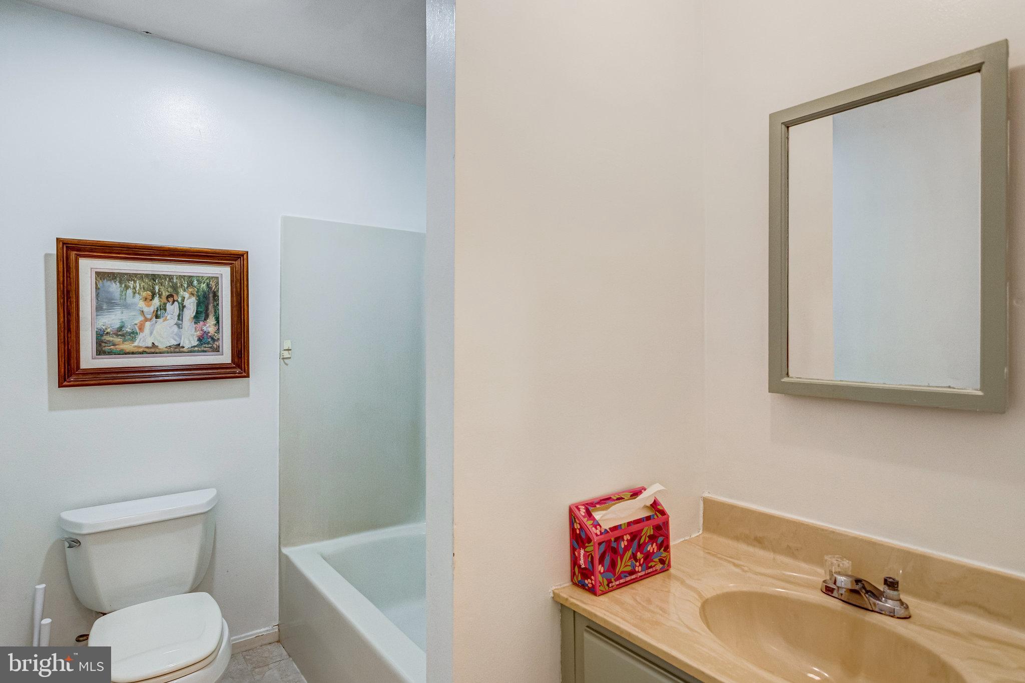 13200 Marsh Road Bealeton, VA 22712 - Photo 14 of 20 a white toilet sitting next to a bathroom sink